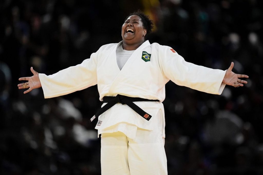 a woman in a white uniform with arms outstretched